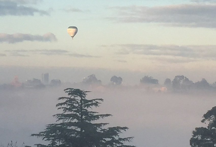 Hot air balloon over Melbourne at sunrise