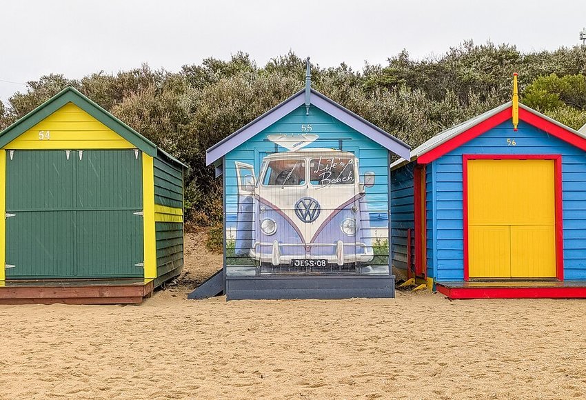 Colourful Brighton bathing boxes beside the beach