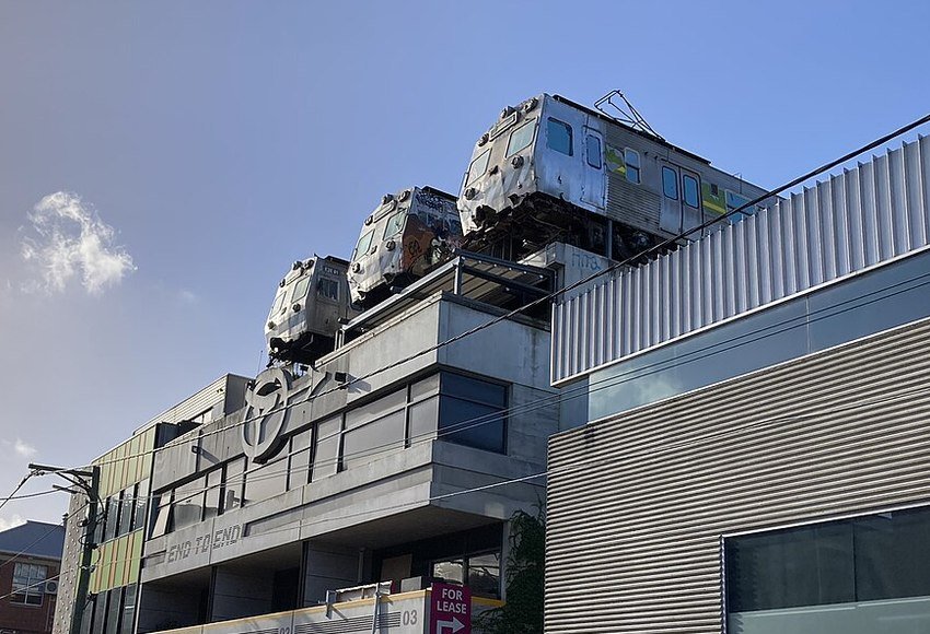 Retired Hitachi train carriages above Easey's rooftop in Collingwood